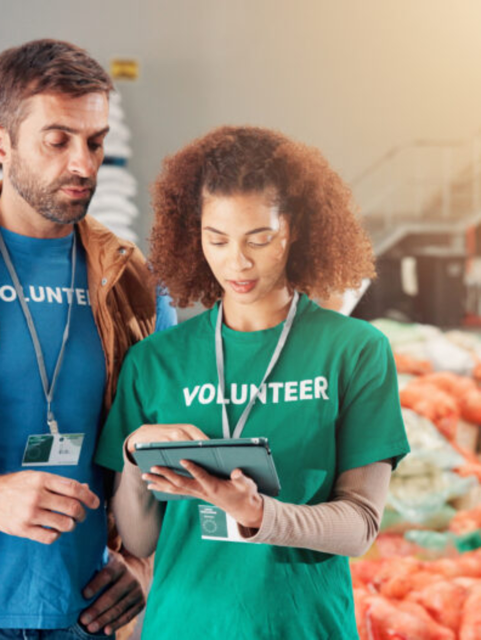 Warehouse, charity and people with tablet, help and review of donations on website and discussion. .