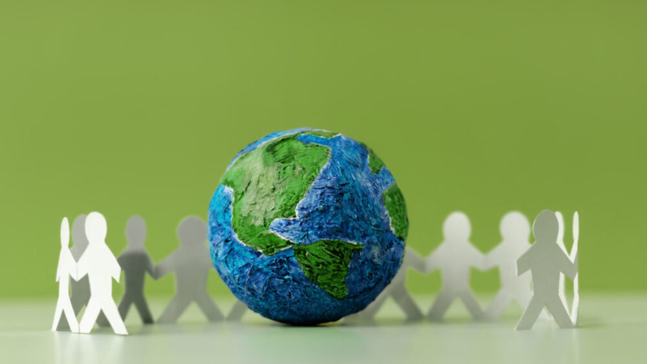 "Global unity concept with paper figures around Earth, representing a Sage Intacct Partner supporting nonprofits.