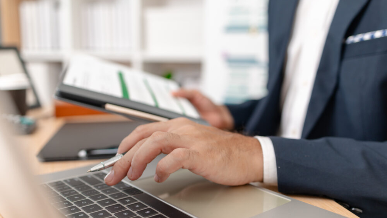 Businessman analysing financial charts to evaluate Sage accounting software performance