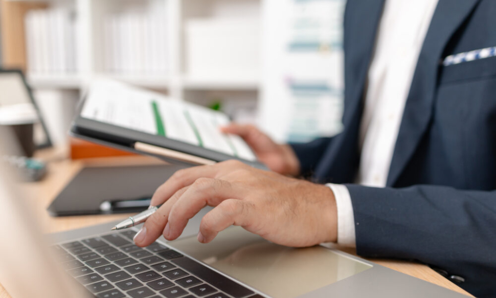 Businessman analysing financial charts to evaluate Sage accounting software performance